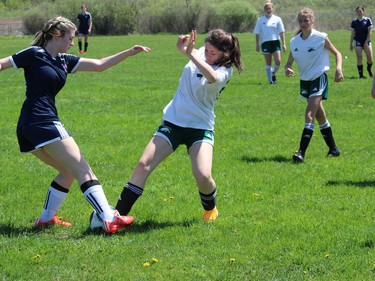 St. Joseph's player Irelyn Virtue (left) and Holy Trinity's Janeeva Herault battle for ball control in the second half of a game on Friday. Photo in Cornwall, Ont. Todd Hambleton/Cornwall Standard-Freeholder/Postmedia Network