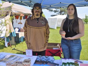 From left, Keane Thompson-Point and Lorna Thomas of the Native North American Training College (NNATC) set up at the Cornwall 1784 event in Lamoureux Park on Friday May 20, 2022 in Cornwall, Ont. Shawna O'Neill/Cornwall Standard-Freeholder/Postmedia Network
