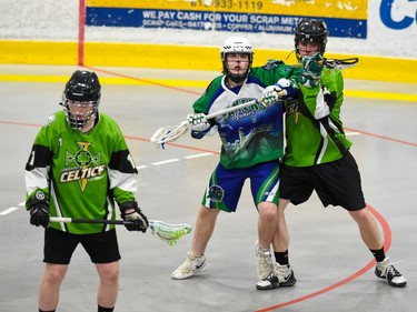 Peterborough Lakers Josh Campbell elbows a Cornwall Celtics player while Celtics Seamus O'Connell watches the play on Sunday May 22, 2022 in Cornwall, Ont. The Lakers won 13-4. Robert Lefebvre/Special to the Cornwall Standard-Freeholder/Postmedia Network