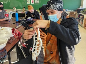Handout/Cornwall Standard-Freeholder/Postmedia Network
An Upper Canada District School Board photo of Quest Thompson restringing his lacrosse stick as part of the after-school lacrosse credit program at Cornwall Collegiate and Vocational School.
