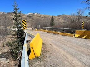 This single-lane wood bridge on the northern gravel section of Fourth Avenue will be replaced this summer. Patrick Gibson/Cochrane Times
