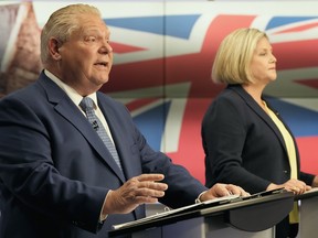 Ontario PC Party Leader Doug Ford speaks as Ontario NDP Leader Andrea Horwath looks on during the party leaders' debate in Toronto, Monday, May 16, 2022.