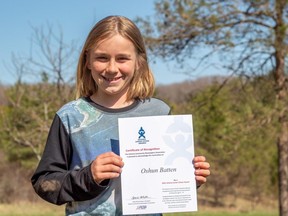 Durham resident Oshun Batten proudly displays his certificate of recognition. He was nominated for the 2021 Ontario Junior Citizen Award for his work collecting litter and raising money for local organizations. Matt Bacon