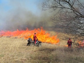 Fire suppression experts monitor and control a prescribed burn north of Hanover on April 24.