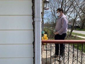 Zachary Typhair of the Green Party stands on the doorstep of a Portsmouth Village house in Kingston on Thursday.