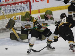 Kingston Frontenacs' Alec Belanger tries to get to a loose puck in front of North Bay Battalion goaltender Dom DiVincentiis as Ty Nelson holds off Belanger during Ontario Hockey League Eastern Conference Semifinal Game 3 action at the Leon's Centre on Tuesday night.