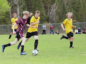 KLDCS' Seth Guertin looks to get by his opponents during recent soccer action. Photo courtesy of Danika Fey.