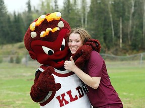 KLDCS' Calleigh Thompson and the school's mascot Spike give each other a big hug. Photo courtesy of KLDCS.