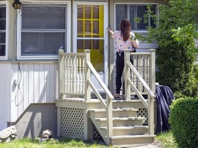 A Lambton County OPP officer knocks on the door of a home as she canvasses a neighborhood where a 27-year-old Exeter man was fatally stabbed May 13, 2022. Two men and a woman were initially charged in the homicide, but the charges were dropped after Michael Compton, 18, from Stratford pleaded guilty to manslaughter on Dec. 13, 2022. (Derek Ruttan/Postmedia Network)