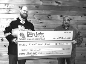 Photo by KEVIN McSHEFFREY/THE STANDARD
Adam MacDonald, branch manager at the TD Bank in Elliot Lake, accepts a $3,000 donation from Paul Noad of the Elliot Lake Red Wings hockey organization. MacDonald accepted the donation on behalf of the Elliot Lake Pride committee.