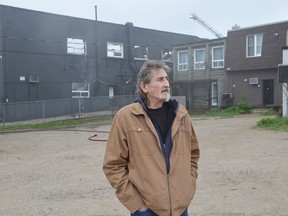 Hanover rooming house resident Rick Howald stands outside the still smouldering building following an early-morning fire on May 19.