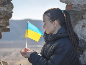A young woman with the flag of Ukraine in her hands. puhimec / Getty Images