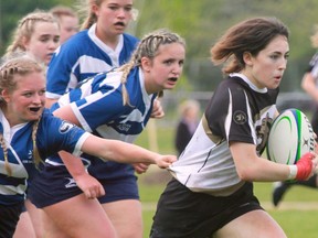 Stratford District secondary school’s Avery Thurston tries to outrun a group of Parkside players during the WOSSAA varsity girls’ rugby final Thursday at SERC. Thurston scored one of two SDSS tries in a 17-12 loss.