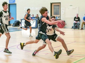 PROVINCIAL HOOPS Nicholas Louttit (with the ball) of the Steel City Slam tries to move past Caden Tubic (7) of the Ancaster Blitz in recent Ontario provincial boys under 15 basketball action that was held in Sault Ste. Marie. BOB DAVIES