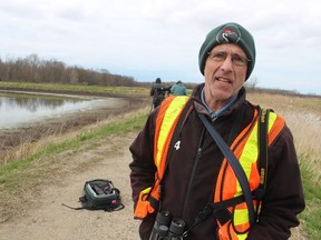 Jack Alvo, a birder from Toronto, speaks Monday about the marsh sandpiper drawing a crowd to the Thedford sewage lagoons.