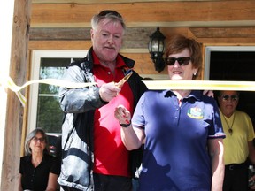 Sarnia Mayor Mike Bradley with Point Edward Mayor Bev Hand cuts the ribbon opening the new Seaway Kiwanis Club of Sarnia-Lambton cabin in Canatara Park.  (Tyler Kula/ The Observer)