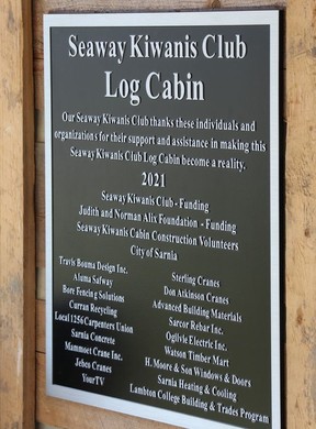 A plaque on the cabin acknowledges groups and individuals that helped make the project possible.  (Tyler Kula/ The Observer)