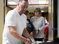 Bill Strangway, past president of the Point Edward Ex-Servicemen's Association, serves roast beef sandwiches during the club's event on Saturday, May 21, 2022 in Point Edward, Ont. Terry Bridge/Sarnia Observer/Postmedia Network