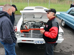 Tony Dupee, right, from Sarnia talks to Rick Martens, left, and Dave Bell about his Chevy II during the Sarnia Street Cruisers event at Preferred Towing on Sunday, May 22, 2022 in Sarnia, Ont.  Terry Bridge/Sarnia Observer/Postmedia Network