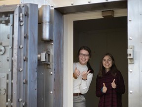 Members of the youth Spoken Hope advisory committee Janessa Labadie, left, and Maura Cook pose in 2019 in the vault at the former-CIBC-branch site for Sarnia-Lambton's Access Open Minds youth mental health facility. The site was recently selected for provincial government funding by Youth Wellness Hubs Ontario. (File photo)