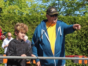 Volunteer Lloyd Blonding gives some pointers to Bentley Dolan, 8, of Sarnia, while he was fishing in the pond at the hatchery in Point Edward Saturday during the Bluewater Anglers' annual Kids' Training Day.