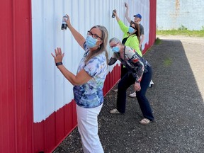 Community Living Access is inviting the community to take part in a mural painting event in celebration of Community Living Month. Getting ready for the project, are, from left, Tricia Morris, executive director; Cheri Emerson, Community Living Access director of service; Shelly Marinic, administrative assistant, and Ainsley Silverthorn of Silverthorn Painting. CONTRIBUTED