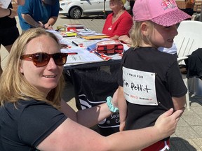 Erika Delong and her daughter Adrianna, 6, of Simcoe prepare for the start of the MS Walk held in Simcoe on Sunday.  The sign on Adrianna's shirt said she was walking for Kim Pettit. About 40 people took part in the walk that started at Holy Trinity Catholic High School. SIMCOE REFORMER