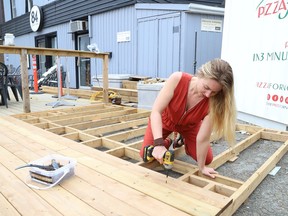 Jessica Casey, of 84 Station in downtown Sudbury, Ont., helps to build a deck at the business on Monday May 2, 2022. John Lappa/Sudbury Star/Postmedia Network