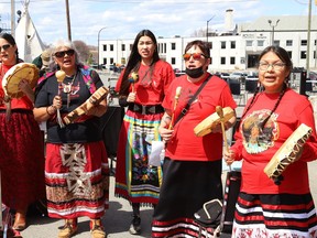 Anishnaabe Kweok Singers perform at a ceremony at the unveiling of the Red Dress Art Reveal at the N'Swakamok Native Friendship Centre in Sudbury, Ont. on Thursday May 5, 2022. The event was held on the National Day of Awareness for Missing and Murdered Indigenous Women, Girls and Two-Spirit people. The art was created by Kathryn Corbiere, of One Kwe Modern Fabrications, and commissioned through the Looking Ahead to Build the Spirit of Our Women Learning to Live Free from Violence project in collaboration with the N'Swakamok Native Friendship Centre. John Lappa/Sudbury Star/Postmedia Network