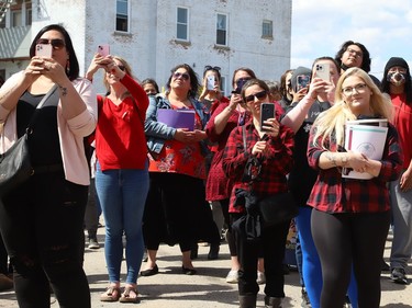 A crowd looks on at a ceremony at the unveiling of the Red Dress Art Reveal at the NÕSwakamok Native Friendship Centre in Sudbury, Ont. on Thursday May 5, 2022. The event was held on the National Day of Awareness for Missing and Murdered Indigenous Women, Girls and Two-Spirit people. The art was created by Kathryn Corbiere, of One Kwe Modern Fabrications, and commissioned through the Looking Ahead to Build the Spirit of Our Women ÐLearning to Live Free from Violence project in collaboration with the NÕSwakamok Native Friendship Centre. John Lappa/Sudbury Star/Postmedia Network