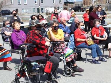A crowd looks on at a ceremony at the unveiling of the Red Dress Art Reveal at the NÕSwakamok Native Friendship Centre in Sudbury, Ont. on Thursday May 5, 2022. The event was held on the National Day of Awareness for Missing and Murdered Indigenous Women, Girls and Two-Spirit people. The art was created by Kathryn Corbiere, of One Kwe Modern Fabrications, and commissioned through the Looking Ahead to Build the Spirit of Our Women ÐLearning to Live Free from Violence project in collaboration with the NÕSwakamok Native Friendship Centre. John Lappa/Sudbury Star/Postmedia Network