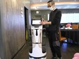 Larry Zhang, manager of 7 Star Dumpling House at 1899 Lasalle Blvd. in Sudbury, Ont., shows off Bella the robot. Bella has been at the restaurant for a week and helps Zhang at the business by delivering meals and drinks to customers at their tables. The robot can also sing happy birthday to patrons celebrating a birthday. John Lappa/Sudbury Star/Postmedia Network