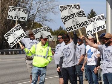 Members of the Carpenters Union local 2486 picket in Azilda, Ont. while taking part in a province-wide strike on Monday May 9, 2022. John Lappa/Sudbury Star/Postmedia Network