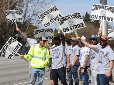 Members of the Carpenters Union local 2486 picket in Azilda, Ont. while taking part in a province-wide strike on Monday May 9, 2022. John Lappa/Sudbury Star/Postmedia Network
