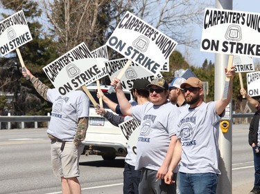 Members of the Carpenters Union local 2486 picket in Azilda, Ont. while taking part in a province-wide strike on Monday May 9, 2022. John Lappa/Sudbury Star/Postmedia Network