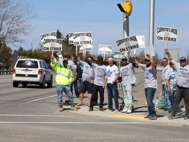 Members of the Carpenters Union local 2486 picket in Azilda, Ont. while taking part in a province-wide strike on Monday May 9, 2022. John Lappa/Sudbury Star/Postmedia Network