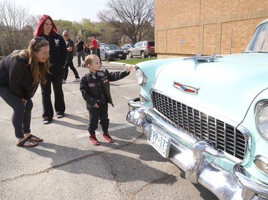 Four-year-old Jackson Twain checks out a classic car as his grandmother, Brenda Lacourciere, left, and his mom, Kayla Ledzwa, look on in Sudbury, Ont. on Wednesday May 11, 2022. Jackson took part in a classic car parade, and he visited the Lorne Street Dairy Queen where he learned to make ice cream cones. He then visited members of the Greater Sudbury Police and rode in a fire truck while visiting the downtown fire station. John Lappa/Sudbury Star/Postmedia Network