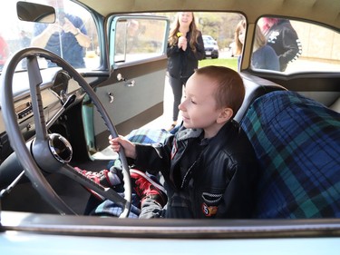 Four-year-old Jackson Twain checks out a classic car in Sudbury, Ont. on Wednesday May 11, 2022. Jackson took part in a classic car parade, and he visited the Lorne Street Dairy Queen where he learned to make ice cream cones. He then visited members of the Greater Sudbury Police and rode in a fire truck while visiting the downtown fire station. John Lappa/Sudbury Star/Postmedia Network