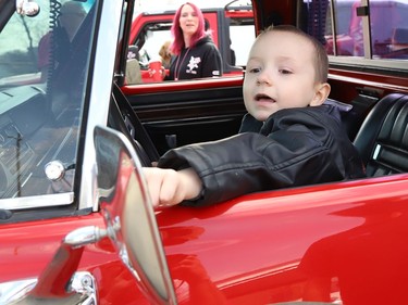Four-year-old Jackson Twain checks out a classic car in Sudbury, Ont. on Wednesday May 11, 2022. Jackson took part in a classic car parade, and he visited the Lorne Street Dairy Queen where he learned to make ice cream cones. He then visited members of the Greater Sudbury Police and rode in a fire truck while visiting the downtown fire station. John Lappa/Sudbury Star/Postmedia Network