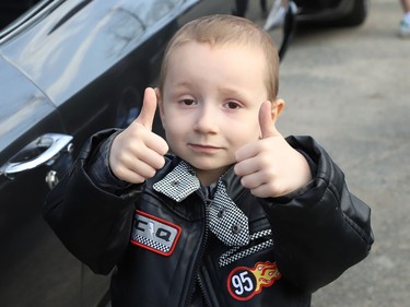 Four-year-old Jackson Twain gives the thumbs up while checking out classic cars in Sudbury, Ont. on Wednesday May 11, 2022. Jackson took part in a classic car parade, and he visited the Lorne Street Dairy Queen where he learned to make ice cream cones. He then visited members of the Greater Sudbury Police and rode in a fire truck while visiting the downtown fire station. John Lappa/Sudbury Star/Postmedia Network