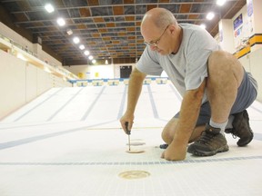 Randy Cavallin, the former pool operator at the Jeno Tihanyi Olympic Gold Pool at Laurentian University (now retired), checks water exhaust ports on the floor of the deep end of the pool in this file photo. The pool remains closed.