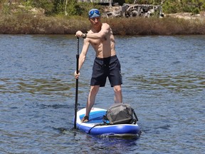 Ray McIvor travels around Silver Lake on his paddle board in Sudbury, Ont. on Friday May 13, 2022. John Lappa/Sudbury Star/Postmedia Network