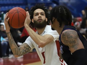 Jeremy Harris, left, of the Sudbury Five, puts up a shot during basketball action against KW Titans at the Sudbury Community Arena in Sudbury, Ont. on Tuesday May 17, 2022. John Lappa/Sudbury Star/Postmedia Network