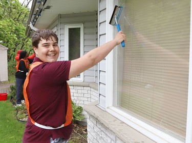 Raphael Delparte, 13, cleans a window at The Walford Sudbury on Thursday May 19, 2022. Grade 8 students from Ecole St-Denis visited the retirement home in Sudbury, Ont. to put their Pay it Forward project into practice by giving back to the local community and seniors. During their visit, students cleaned windows, doors and siding, swept the grounds, repaired flower beds, painted benches and cleaned up the property. John Lappa/Sudbury Star/Postmedia Network