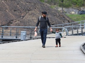 Josh Turnbull and his daughter, Joni Rae, 2, go for a walk on the dock near Science North in Sudbury, Ont. on Friday May 20, 2022. John Lappa/Sudbury Star/Postmedia Network