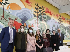 Bill Best, left, president of Cambrian College, and Cambrian art students Perry Kessler, Lumen Jefferson, Asha Sokolowicz, Mars Petryna and Ivy Pellerin, and Johanna Westby, Cambrian professor in the School of Creative Arts and Design, and Cambrian College dean Brian Lobban were on hand for the official unveiling of a massive mural at Lo-Ellen Park Secondary School in Sudbury, Ont. on Friday May 20, 2022. The mural, entitled Northern Resurgence, "is a tribute to the resiliency of the northern landscape," said a release issued by the Rainbow District School Board. The mural was created by nine Cambrian College art students and professor Westby. "It is the largest mural so far," that's been created by students in Cambrian's School of Creative Arts and Design, said Westby. It measures about 16 metres by 2.4 metres and it took about 270 hours to complete. John Lappa/Sudbury Star/Postmedia Network