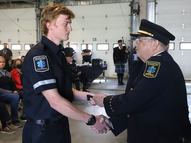 Joseph Nicholls, right, general manager of Community Safety for Greater Sudbury, presents new paramedic Nic Kreutzweiser with epaulettes during a ceremony marking national Paramedic Week at the Lionel E. Lalonde Centre in Azilda, Ont. on Tuesday May 24, 2022. John Lappa/Sudbury Star/Postmedia Network