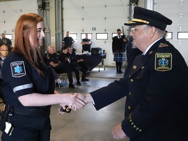 Joseph Nicholls, right, general manager of Community Safety for Greater Sudbury, presents new paramedic Brianna Smith with epaulettes during a ceremony marking national Paramedic Week at the Lionel E. Lalonde Centre in Azilda, Ont. on Tuesday May 24, 2022. John Lappa/Sudbury Star/Postmedia Network