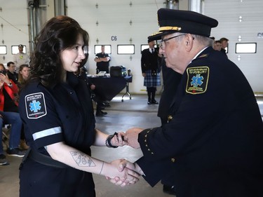 Joseph Nicholls, right, general manager of Community Safety for Greater Sudbury, presents new paramedic Mckenna Urso with epaulettes during a ceremony marking national Paramedic Week at the Lionel E. Lalonde Centre in Azilda, Ont. on Tuesday May 24, 2022. John Lappa/Sudbury Star/Postmedia Network