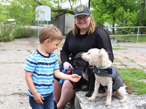 Coulson Buck, 4, greets Cindy Somerville's dogs, Bailey and Cesar, on the shoreline at Science North in Sudbury, Ont. on Wednesday May 25, 2022. John Lappa/Sudbury Star/Postmedia Network